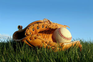 baseball and mitt on outfield grass