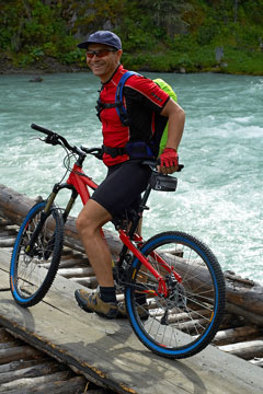 mountain biker on wooden bridge