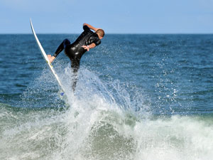 professional surfer jumping off wave